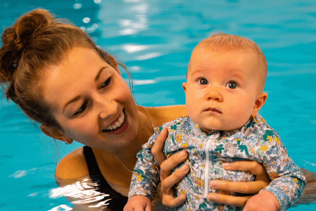 A mum and baby attend a baby swimming lesson together