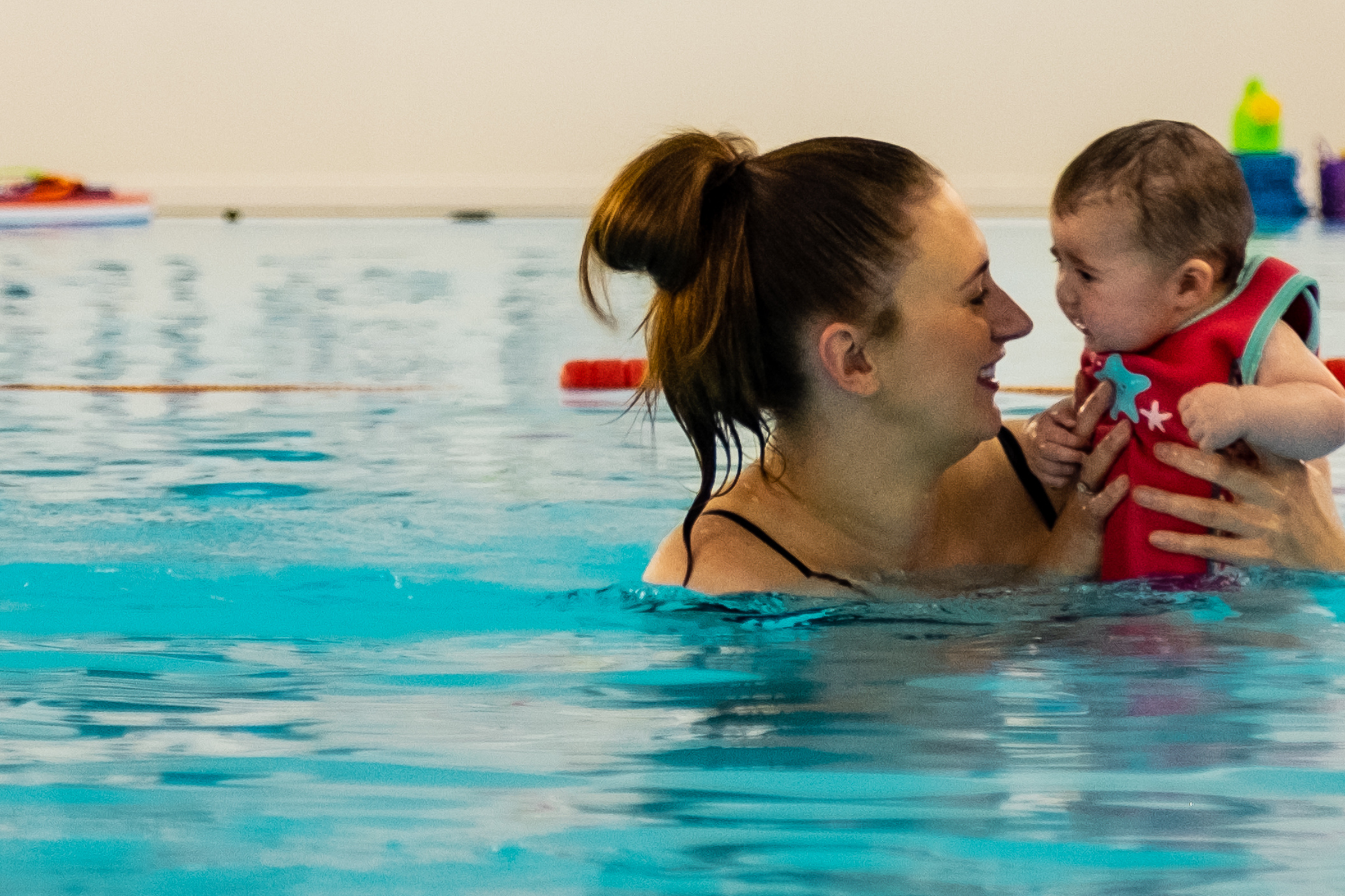 A mum and baby enjoy some quality bonding time during a baby swimming lesson