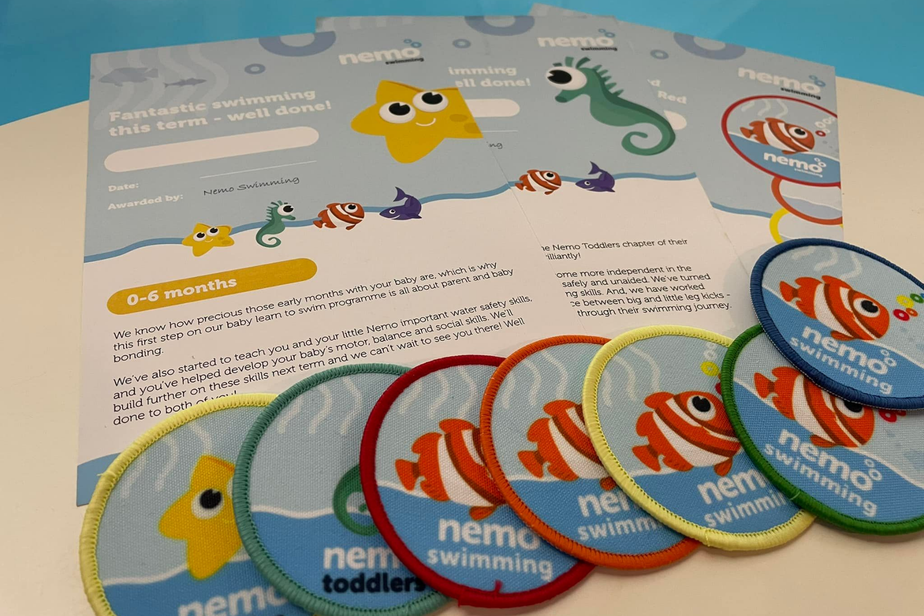 A collection of Nemo Swimming badges and certificates