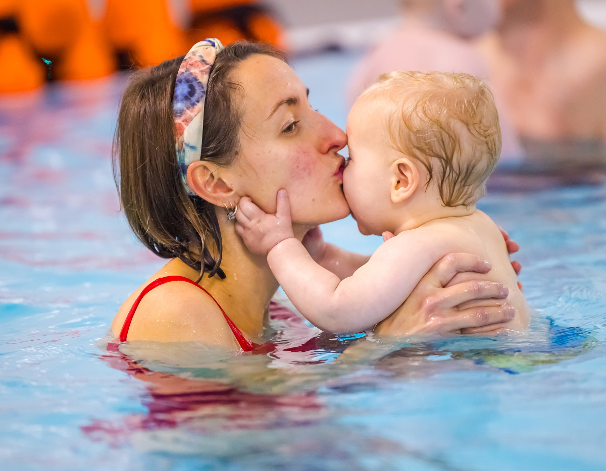 A mum and baby enjoy a cuddle in the swimming pool