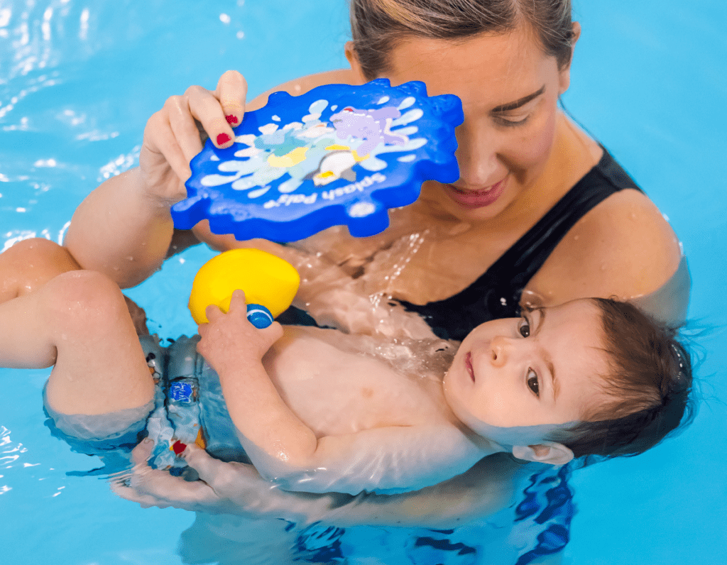 35 A toddler floats on their back in the swimming pool