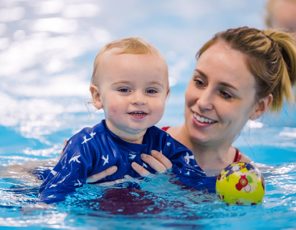 A toddler and mum enjoy a swimming lesson together