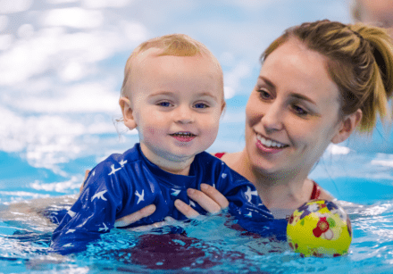 A toddler and mum enjoy a swimming lesson together